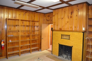 The adjoining room.  Behind the book shelves and pine panelling is room in the above photo